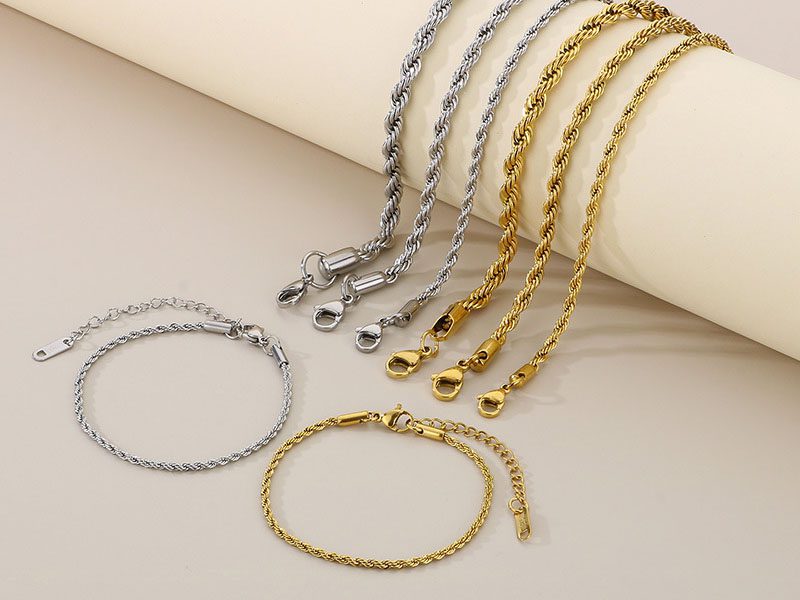 A set of silver and gold stainless steel rope chain bracelets with a sleek design, featuring lobster clasps and adjustable chains.