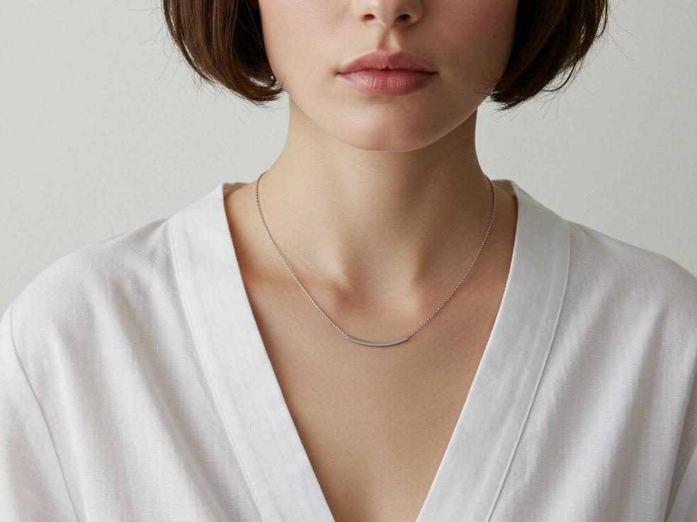 A close-up of a woman wearing a 16-inch silver bar necklace, showcasing its fit and appeal for wholesale jewelry buyers.
