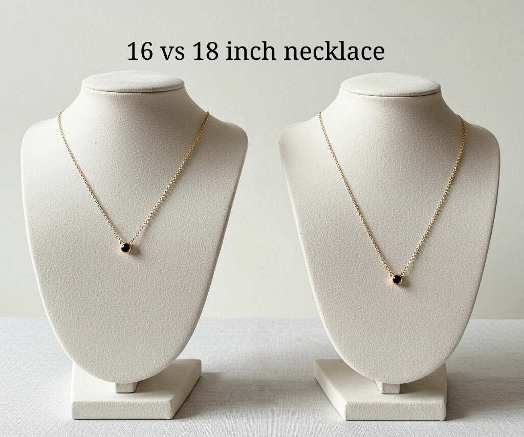 A side-by-side comparison of 16-inch and 18-inch gold necklaces with black stone pendants displayed on necklace busts, highlighting the difference in length.