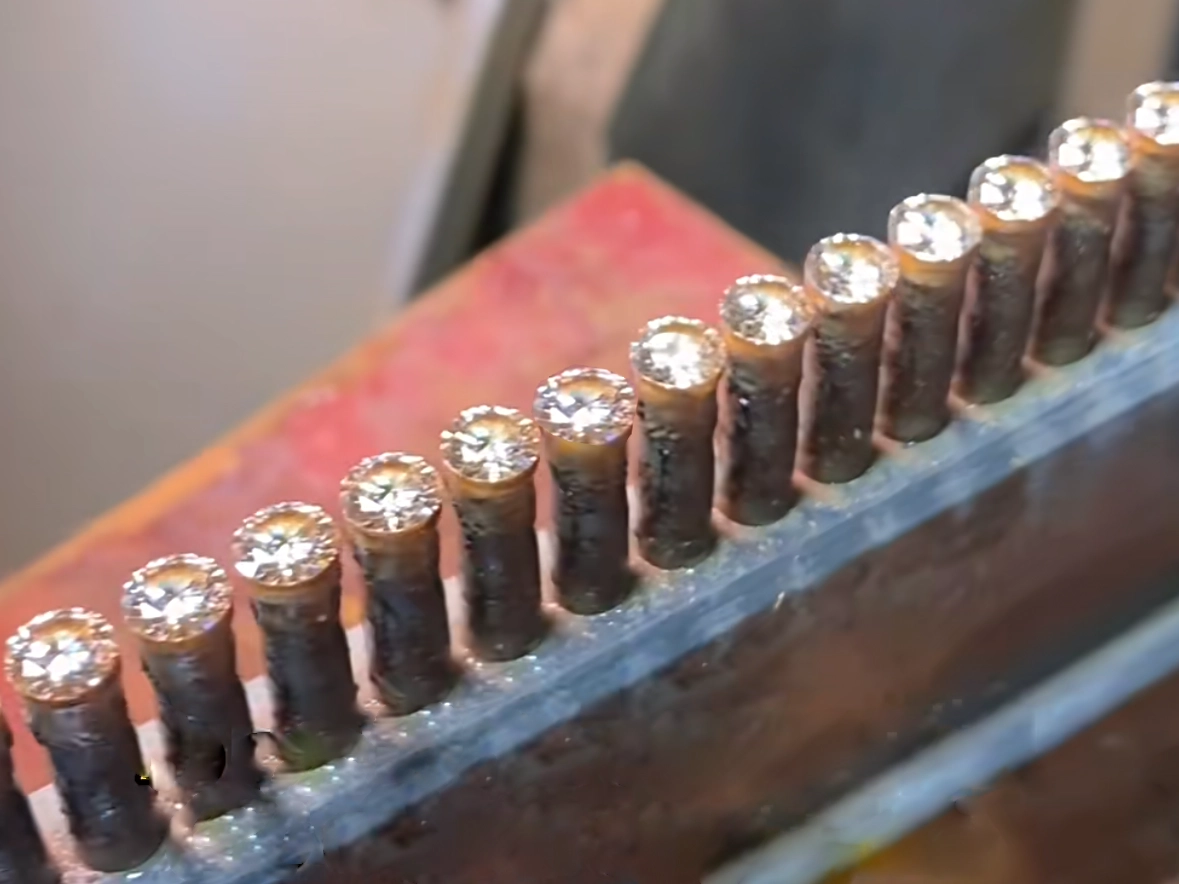 A close-up view of moissanite gemstones in the production process, mounted for cutting and polishing. While moissanite is an affordable diamond alternative, bulk jewelry buyers face challenges such as high return rates, inconsistent quality, and customer dissatisfaction, raising concerns about its long-term viability in the jewelry market.