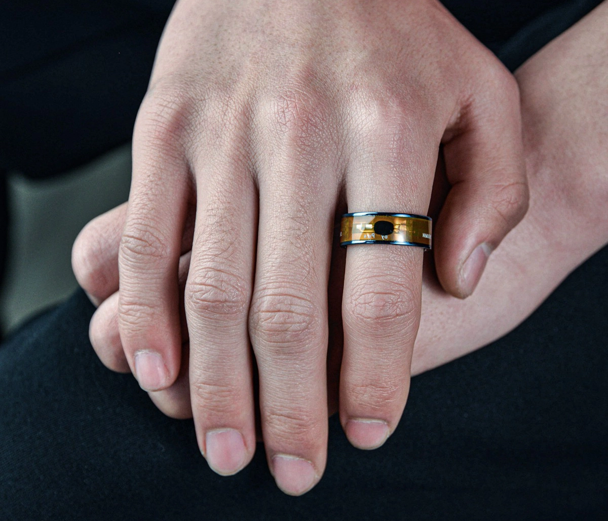 A modern stainless steel ring with an embedded smart chip, worn on a hand, showcasing an innovative high-profit design for wholesale buyers.