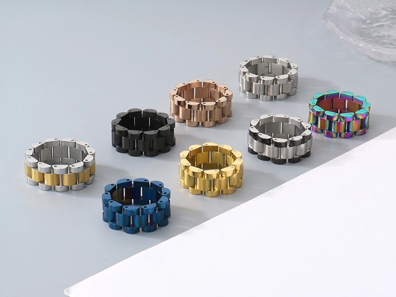 A set of stainless steel bike chain link rings in various colors, including silver, gold, black, blue, and rainbow.