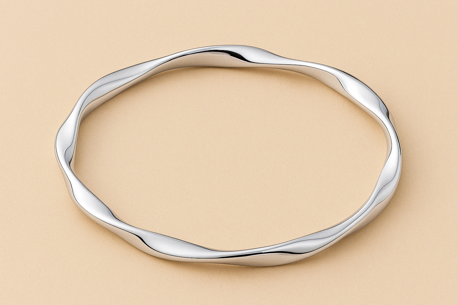 Circular silver bangle bracelet with a smooth, wavy design, showcasing a classic slip-on style.