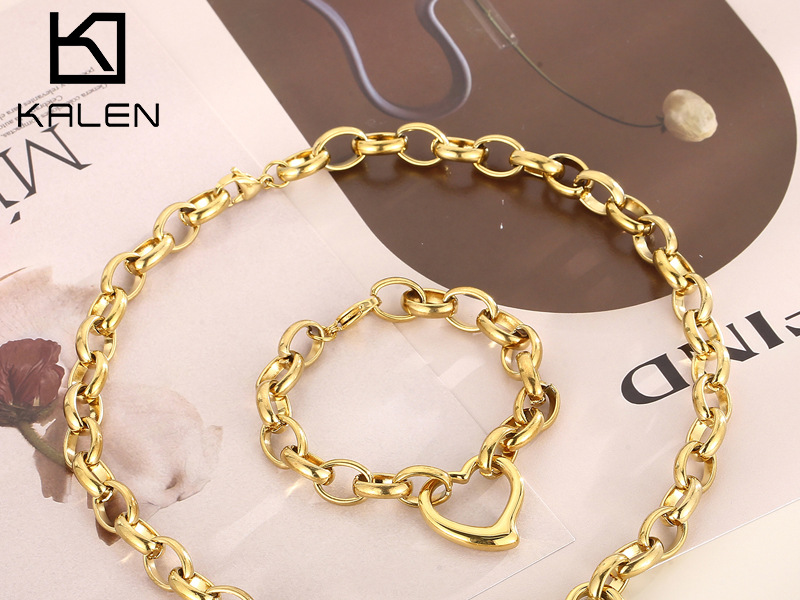 Gold-tone chain necklace and bracelet set by Kalen, featuring a chunky link design and a heart-shaped charm.